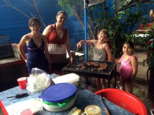 Elayne grilling some carne asada at the outdoor pool park, along with the ladies of the Rey family!